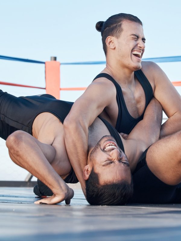 Men, wrestling and competition in a ring, mat or athlete winning in a tournament, match or training.